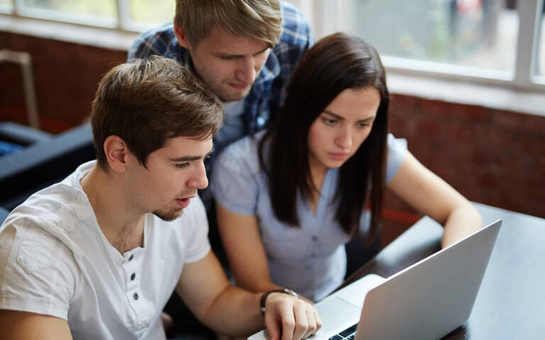 team looking at a screen during a presentation