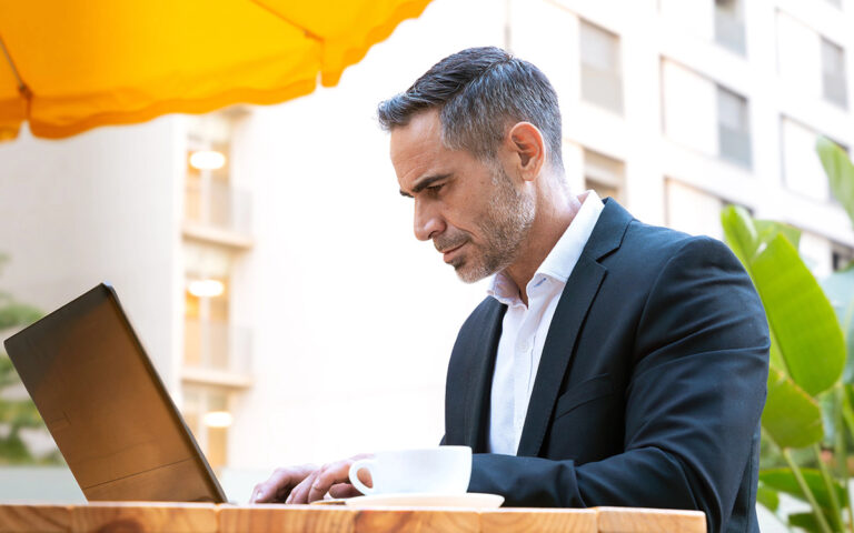 businessman working on his laptop outdoors