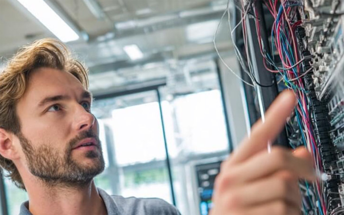 IT manager working with server cables