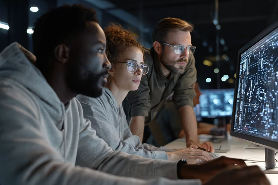 team looking at data in the computer