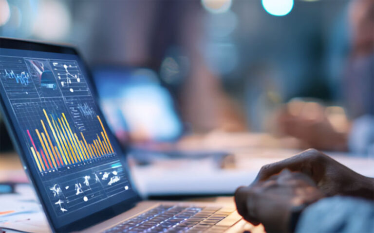 man working with data on a laptop