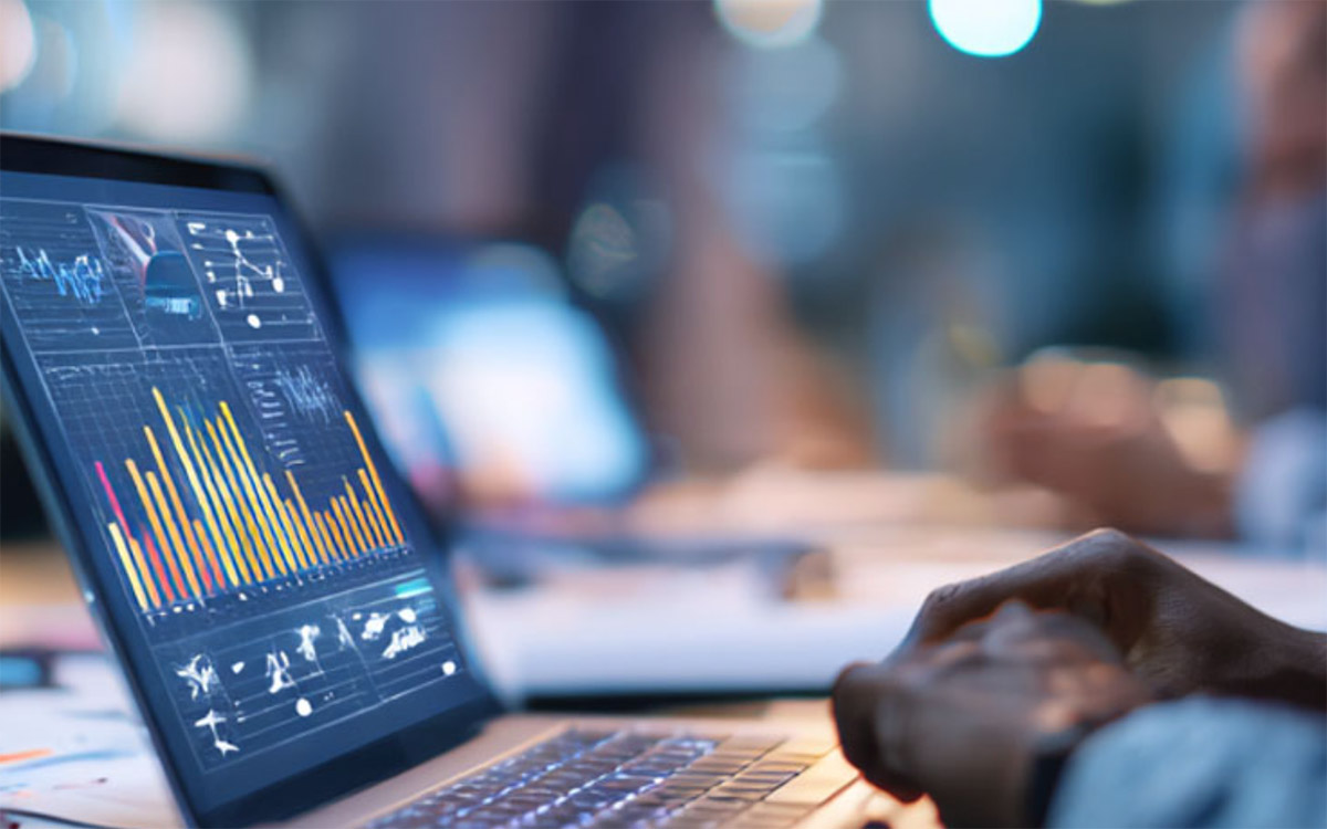 man working with data on a laptop