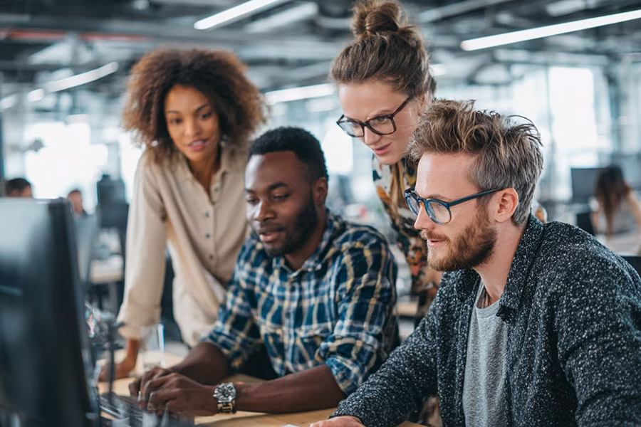 team looking at a computer at the office