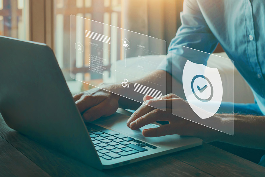 man working on his laptop with security check