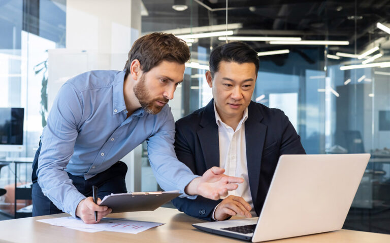 Coworkers at the office looking at documents online
