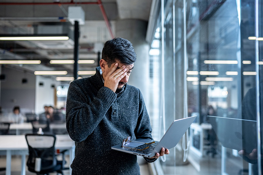 man at the office worried looking at documents