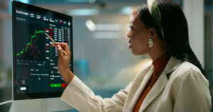 Woman working on her computer with data on screen