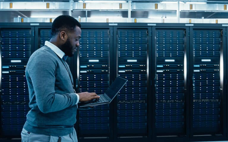 business IT manager working next to servers