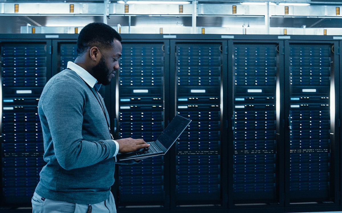 business IT manager working next to servers