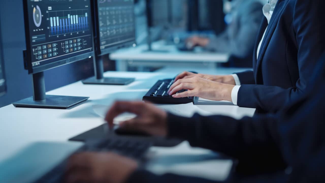 Employees typing on keyboards
