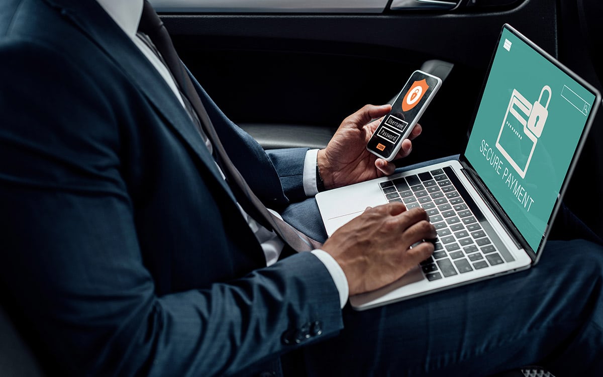 businessman working on his phone and laptop