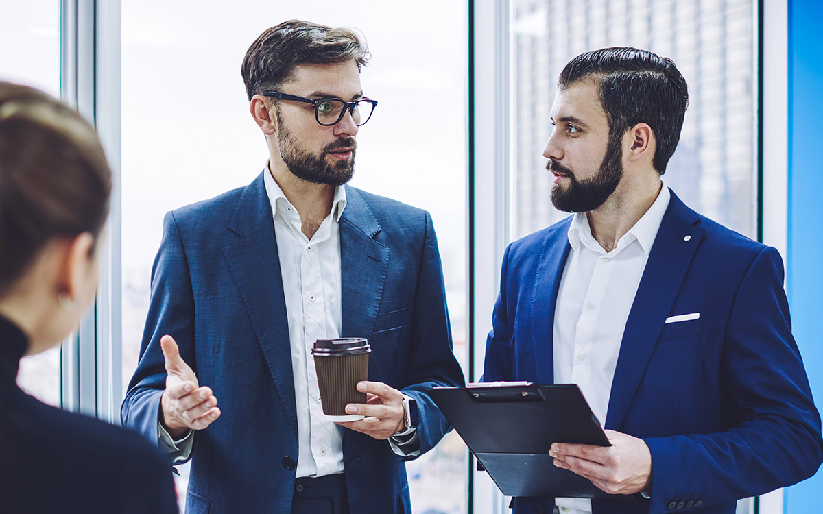 lawyers talking with client at an office