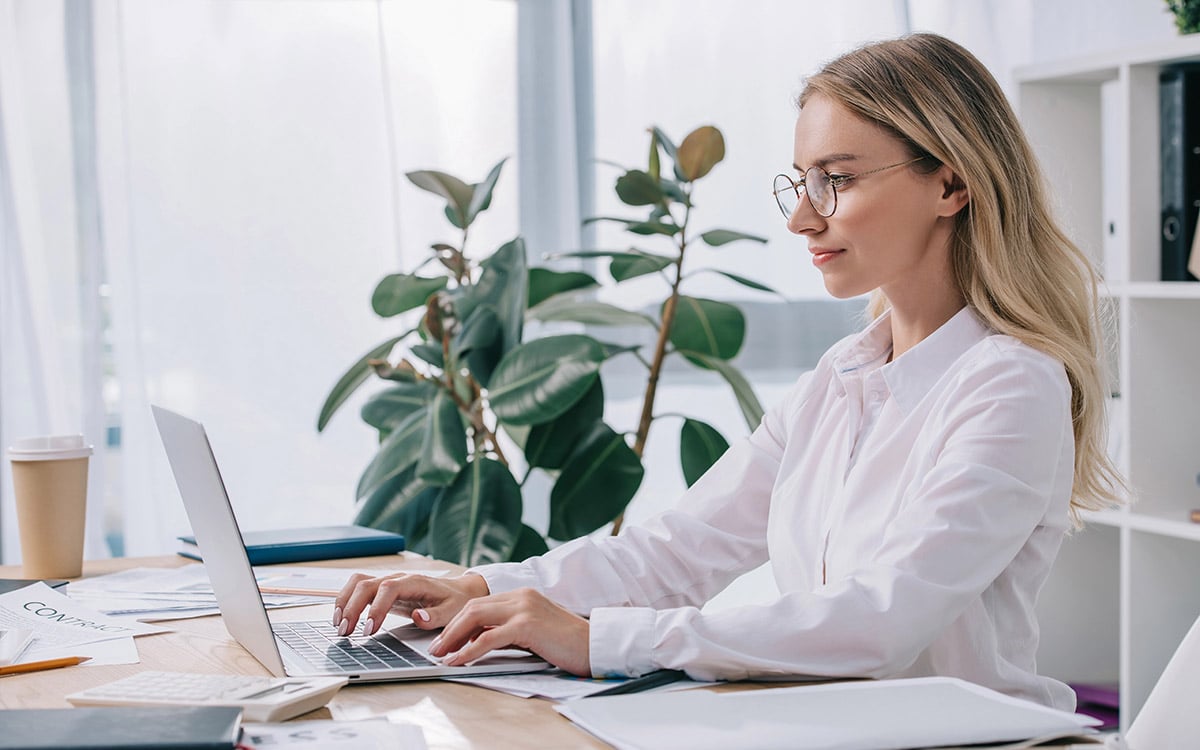woman working at her office on a laptop